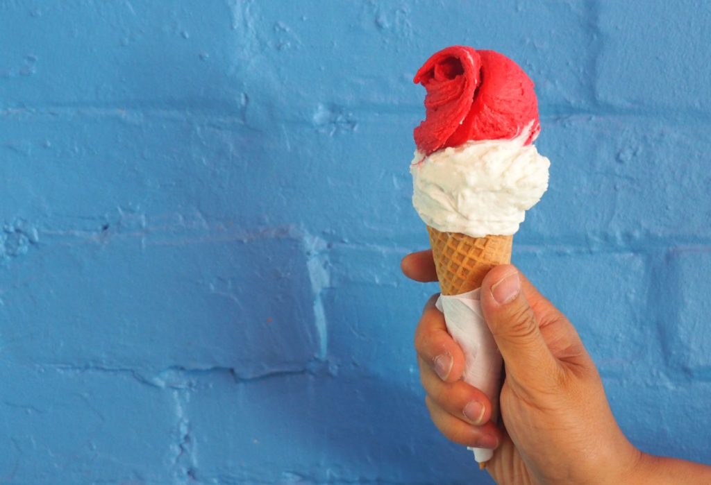 Coconut gelato topped with a swirl of raspberry sorbetto.