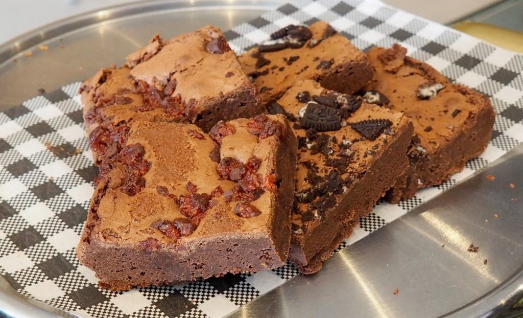 Some brownies come with toppings of Cherry Ripes, Oreo cookies or mint slice.