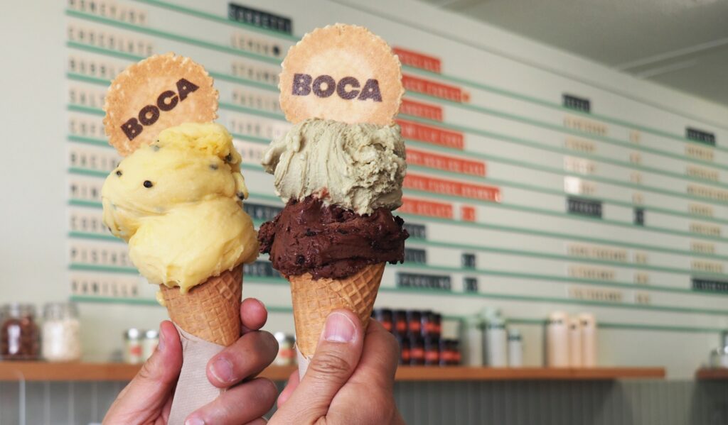 A pair of sorbettos - mango and passionfruit - on the left. On the right, a classic pistachio gelato with black forest gelato.
